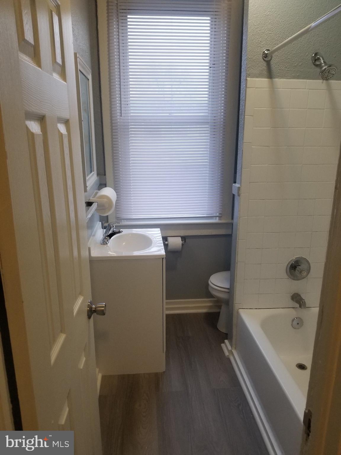 3109 Lawnview Avenue Baltimore, MD 21213 - Photo 11 of 23 a bathroom with a bathtub sink and toilet