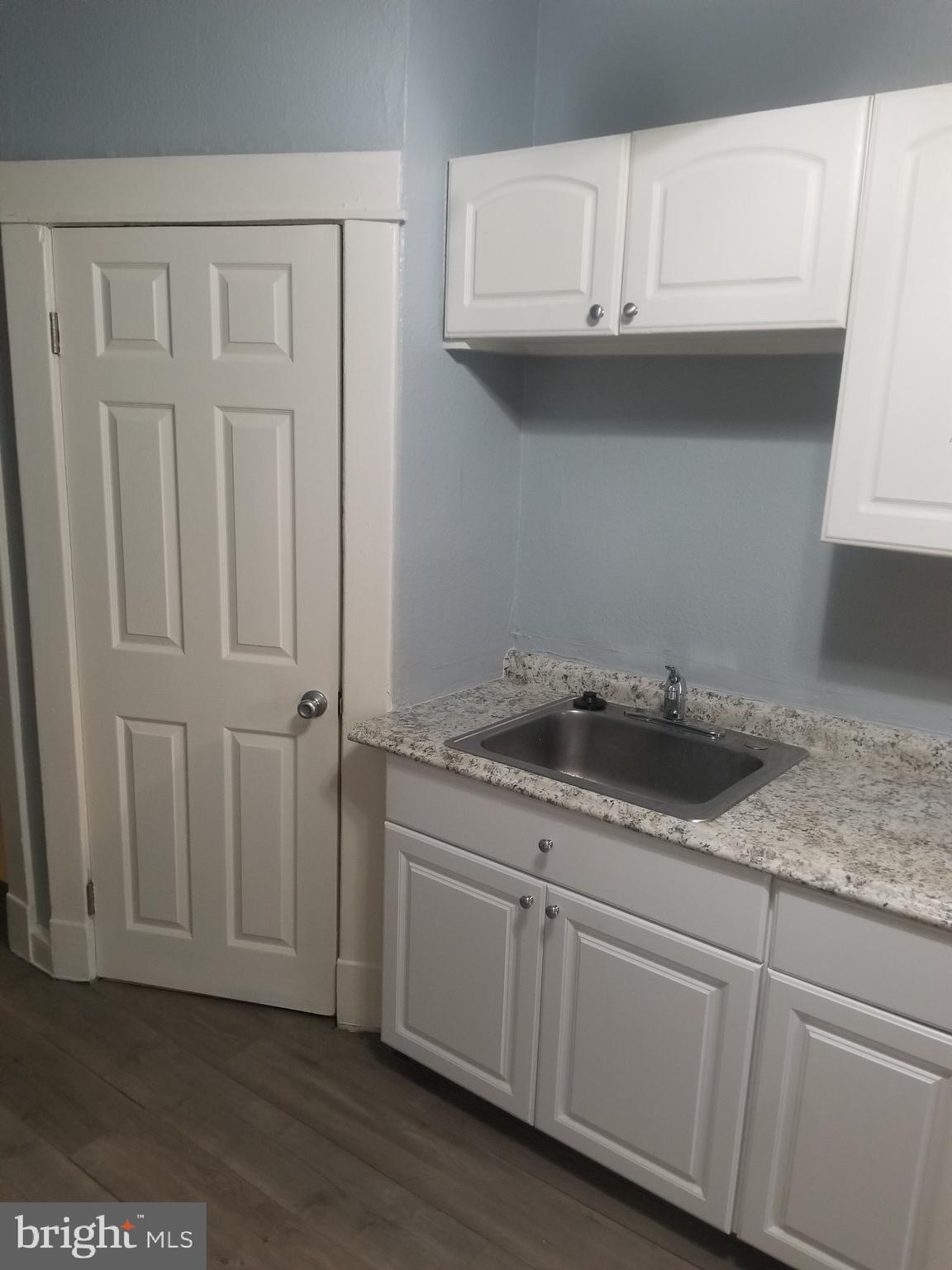 3109 Lawnview Avenue Baltimore, MD 21213 - Photo 3 of 23 a kitchen with a sink and cabinets