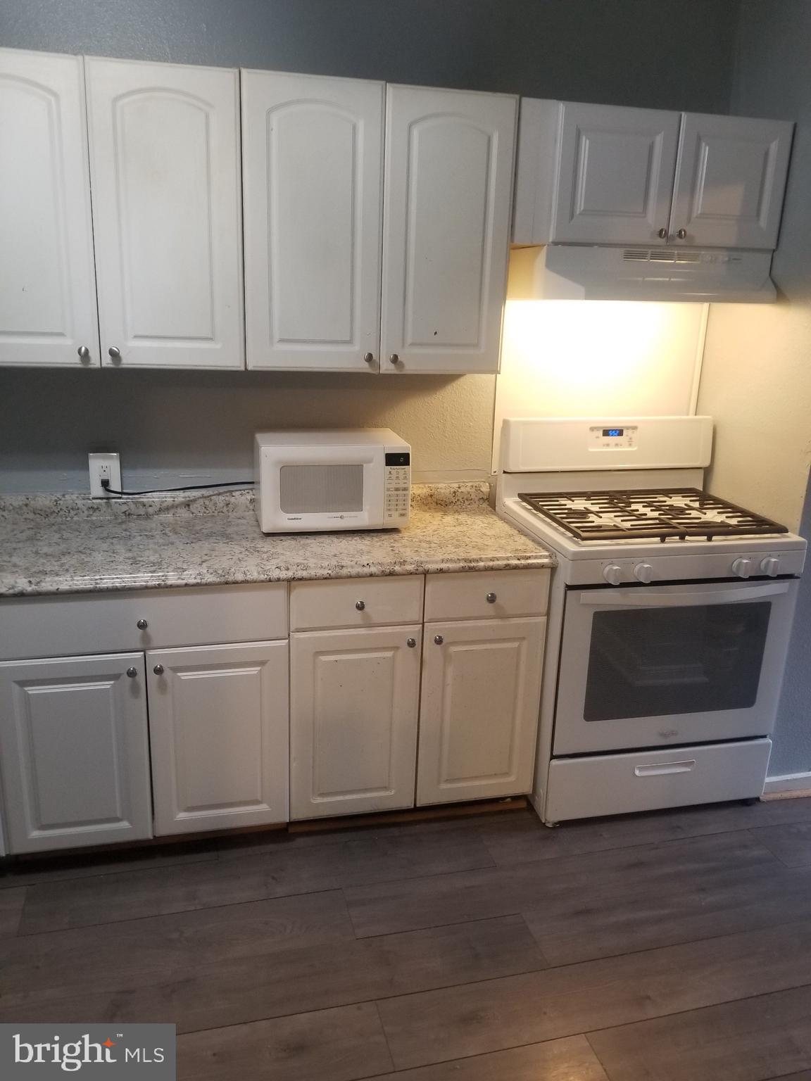 3109 Lawnview Avenue Baltimore, MD 21213 - Photo 5 of 23 a kitchen with granite countertop white cabinets and white appliances