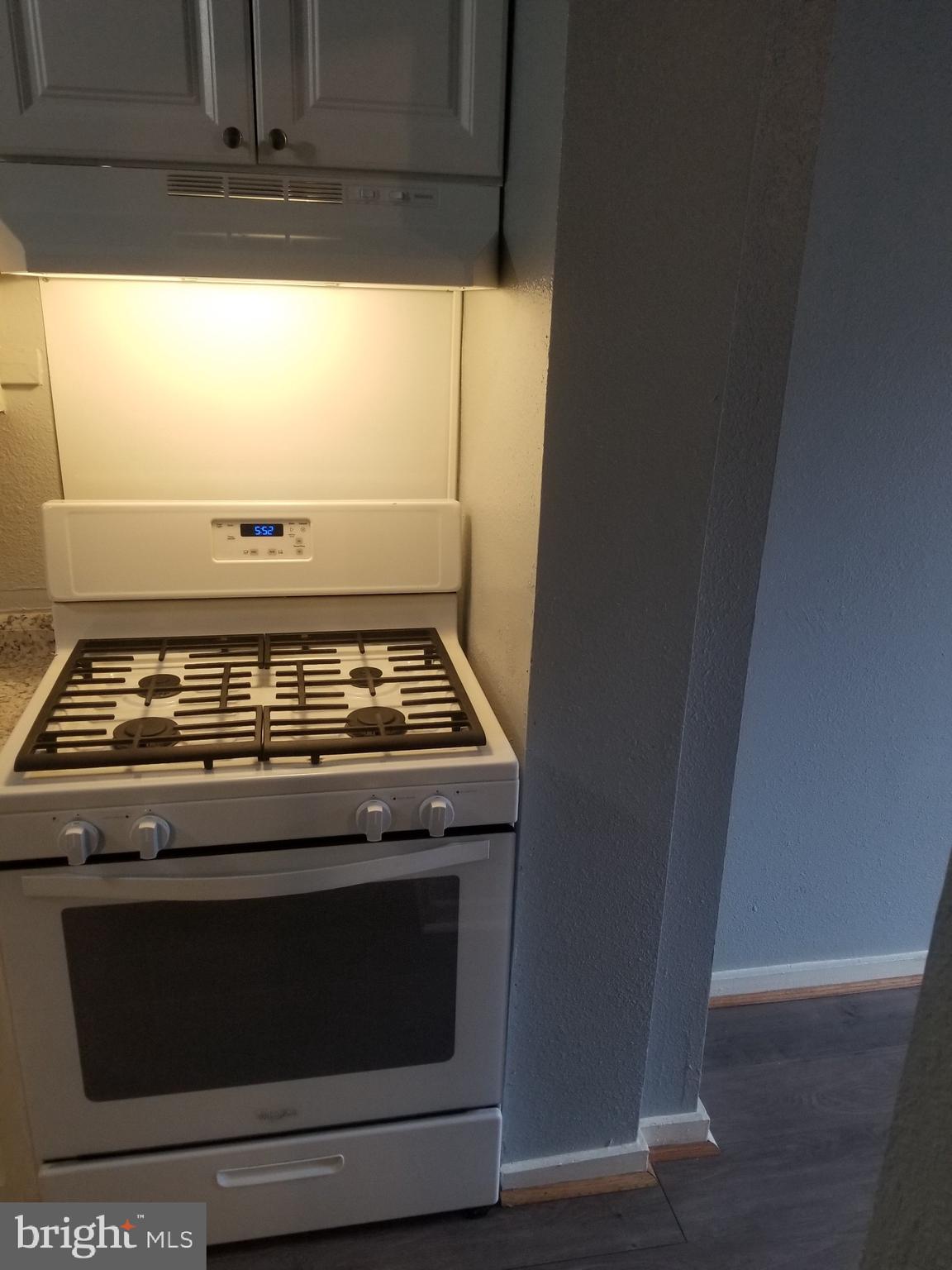 3109 Lawnview Avenue Baltimore, MD 21213 - Photo 6 of 23 a stove top oven sitting inside of a kitchen