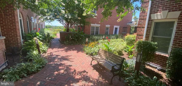 a front view of a house with a yard and outdoor seating