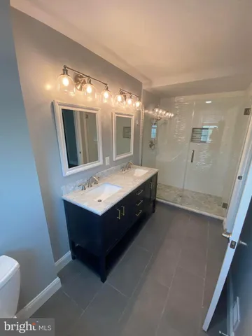 a bathroom with a sink vanity and mirror