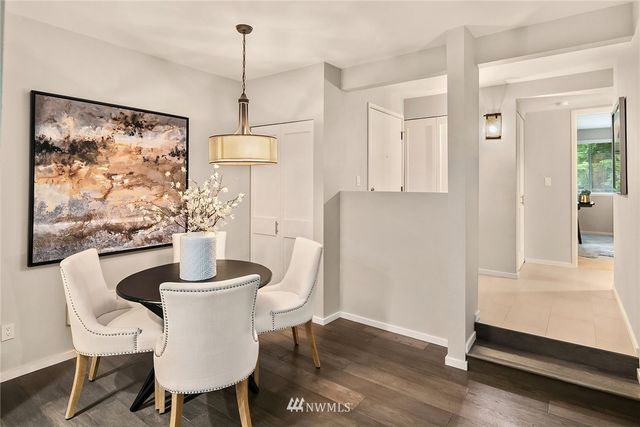 a dining room with furniture and wooden floor