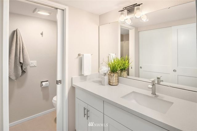 a bathroom with a sink a vanity and a mirror