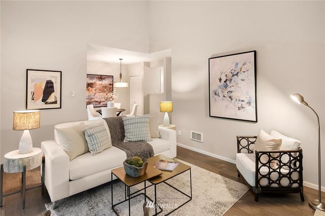 a living room with furniture and painting on the wall