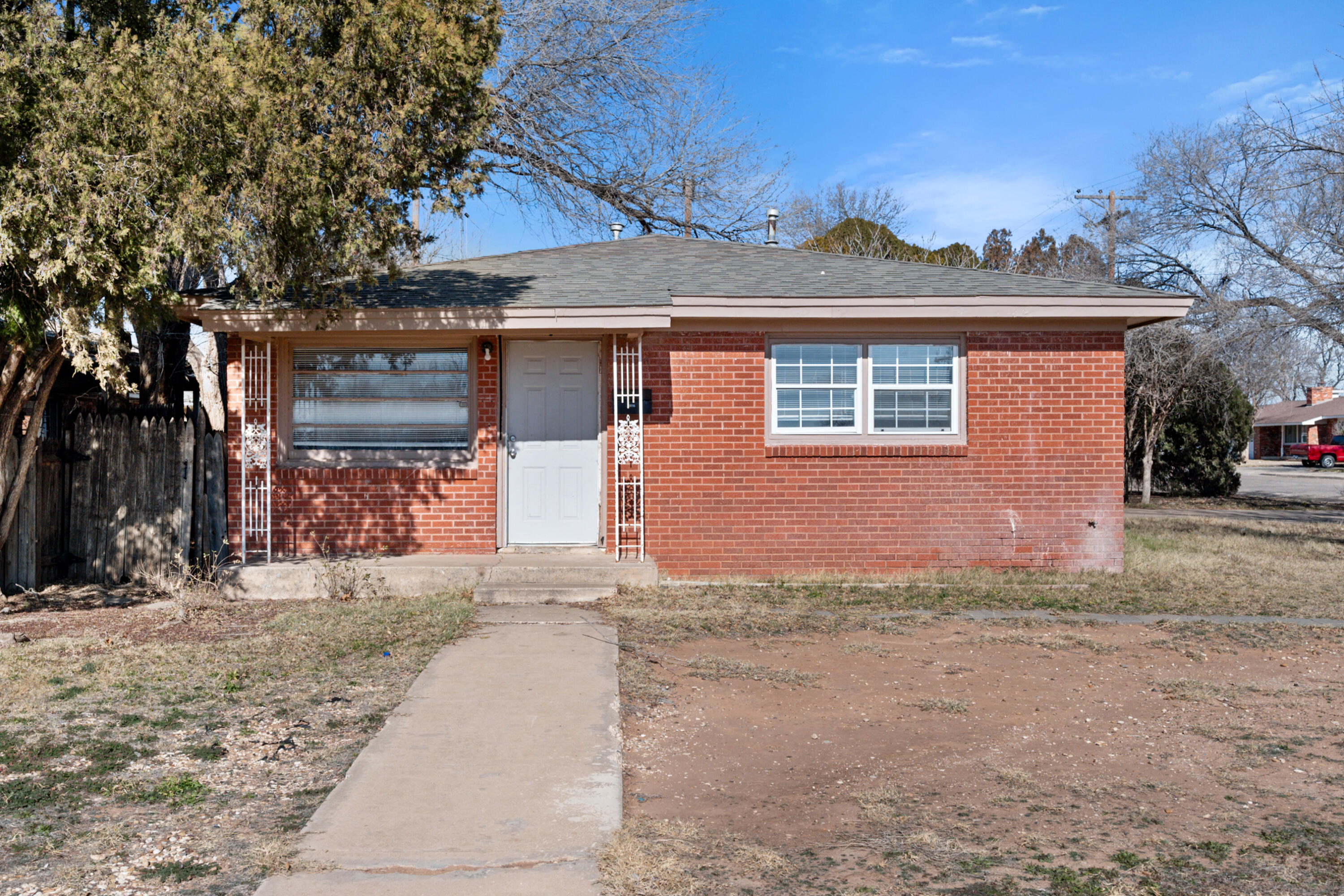 2302 62nd Street Lubbock, TX 79412 - Photo 2 of 38 a front view of a house with a yard and garage