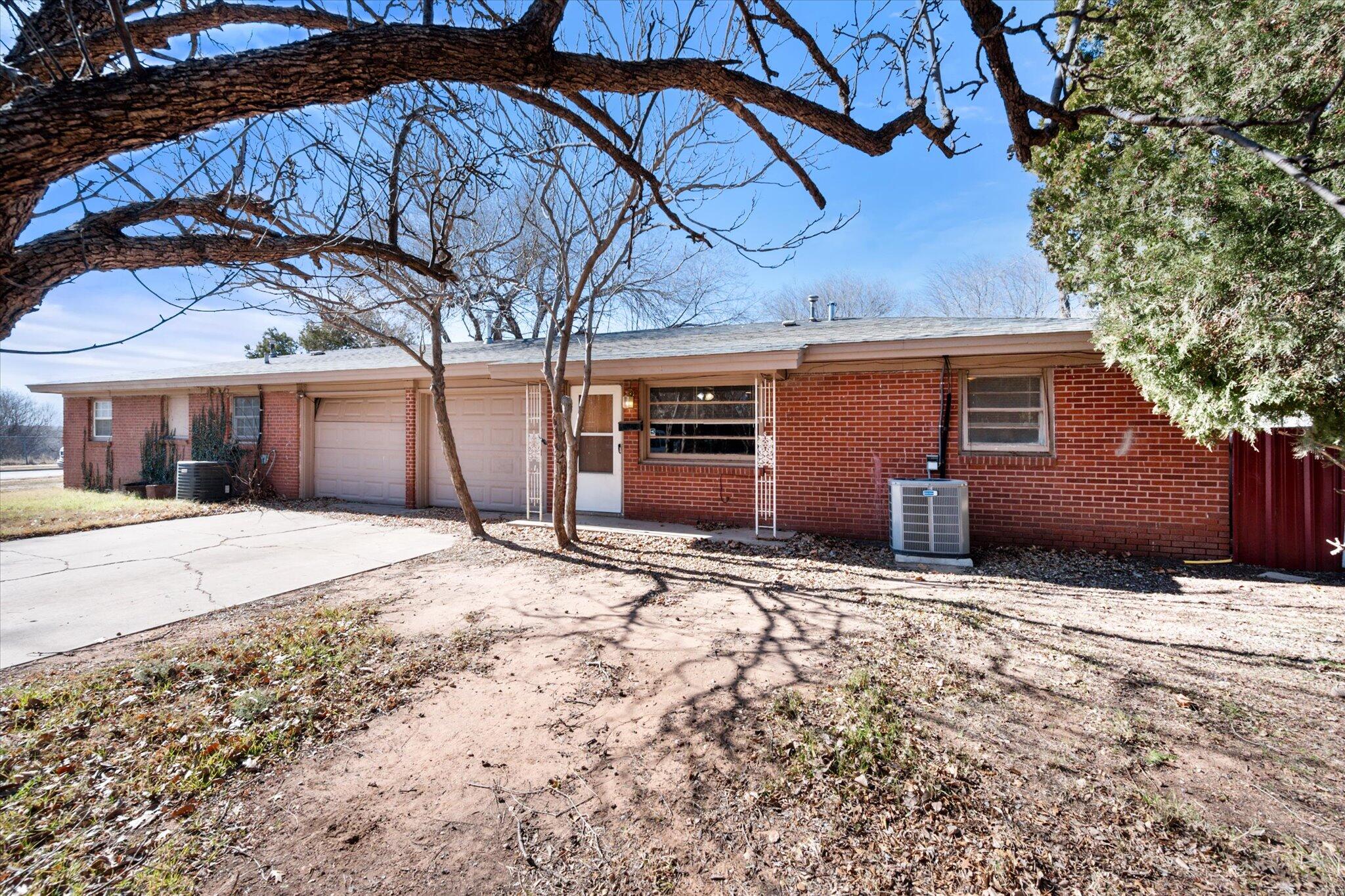 2302 62nd Street Lubbock, TX 79412 - Photo 5 of 38 a house with trees in front of it