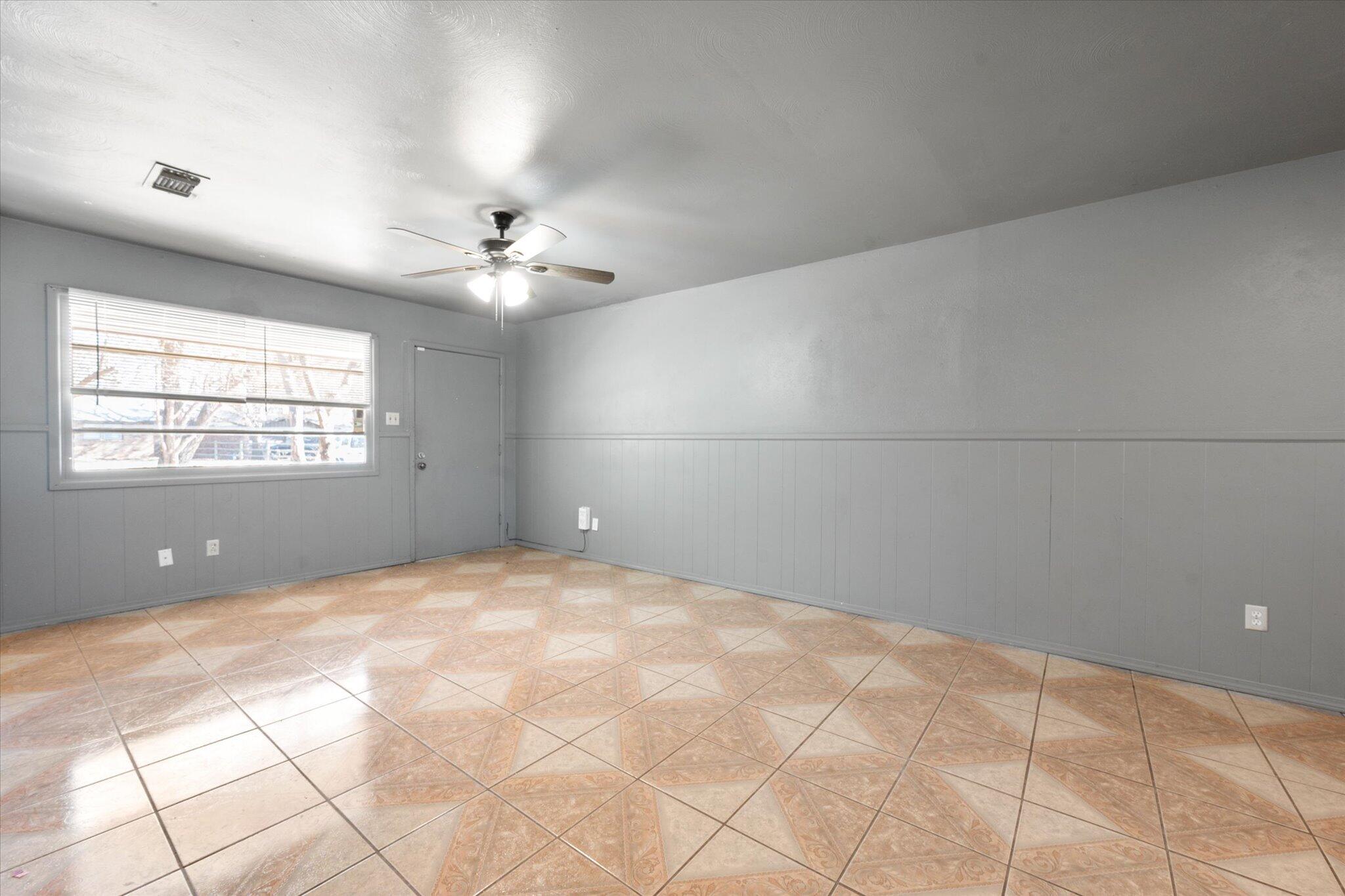 2302 62nd Street Lubbock, TX 79412 - Photo 9 of 38 a view of a room with a ceiling fan and window