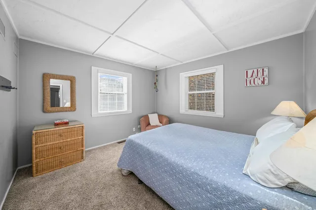 a kitchen with stainless steel appliances granite countertop a sink a stove a refrigerator and island with wooden floor