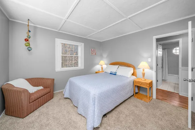 a kitchen with stainless steel appliances granite countertop a stove top oven a sink dishwasher and a refrigerator with wooden floor