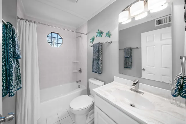 a large kitchen with kitchen island white cabinets and stainless steel appliances