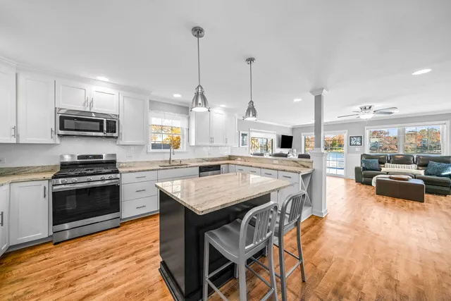 a living room with furniture a fireplace and wooden floor