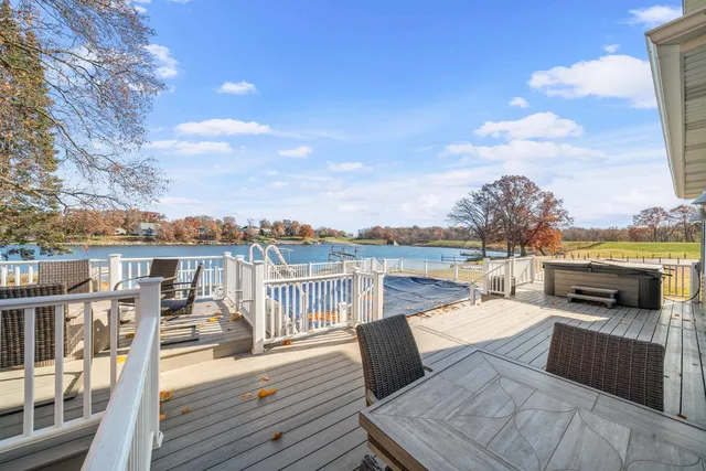 a spacious bathroom with a double vanity sink a large mirror and shower