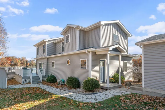 a kitchen with stainless steel appliances granite countertop a stove a sink dishwasher a dining table and chairs with wooden floor