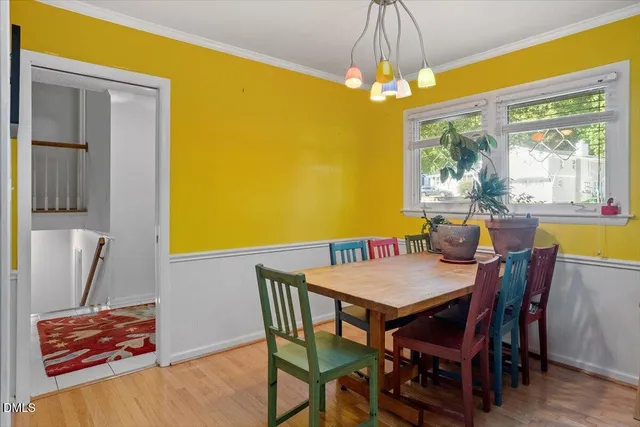 a view of a dining room with furniture and a chandelier