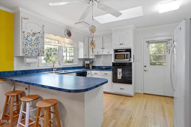 a kitchen with stainless steel appliances granite countertop a sink a stove and a refrigerator