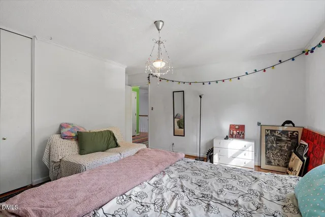 a bedroom with a bed and a chandelier