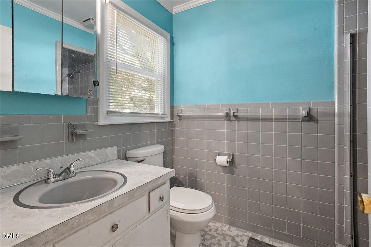 2100 Nancy Ann Drive Raleigh, NC 27607 - Photo 28 of 33 a bathroom with a sink a toilet and a mirror