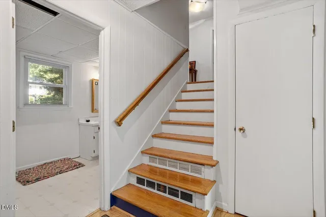 a view of entryway with wooden floor and front door