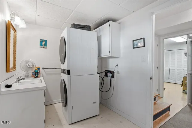 a bathroom with a sink and mirror with shower