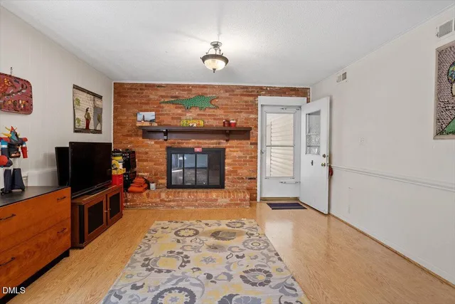 a living room with a flat screen tv and a fireplace