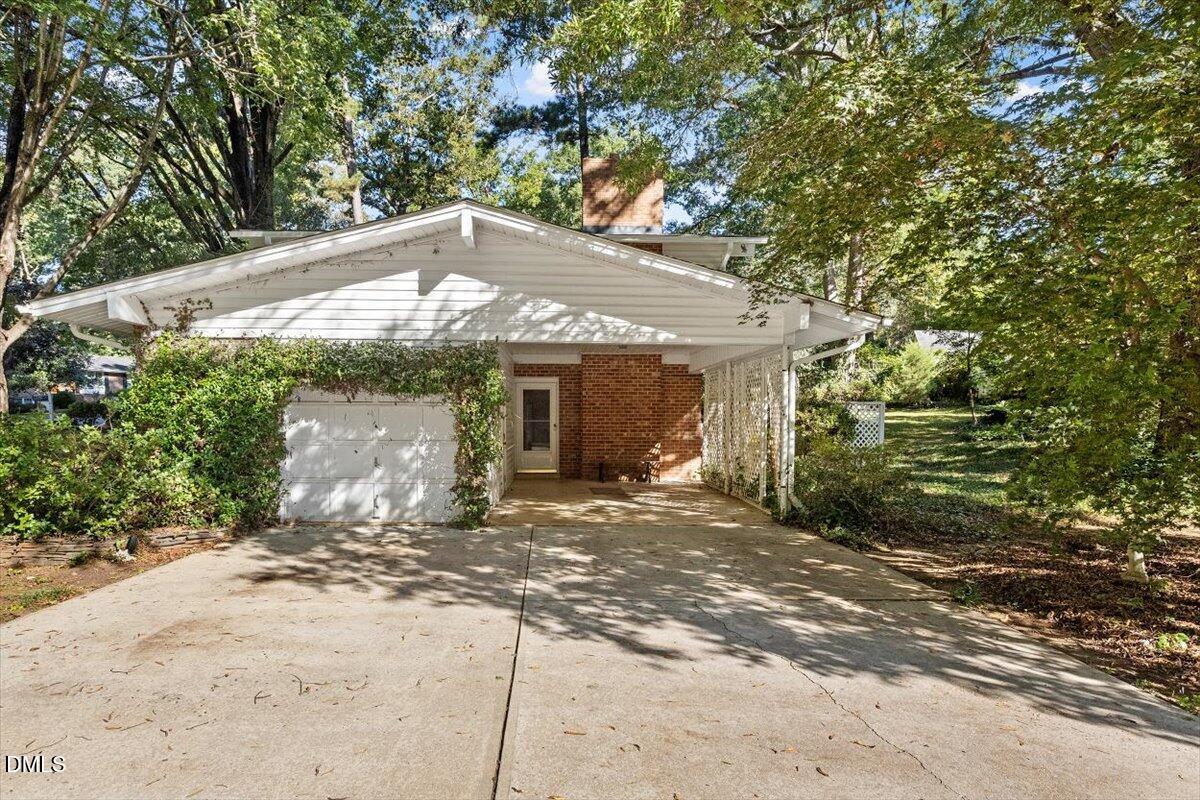 2100 Nancy Ann Drive Raleigh, NC 27607 - Photo 5 of 33 a front view of a house with a garden