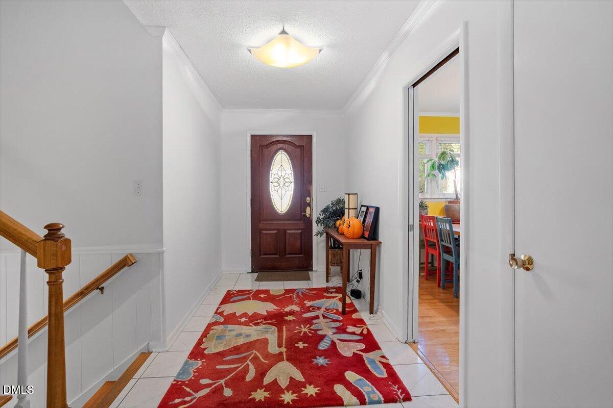 2100 Nancy Ann Drive Raleigh, NC 27607 - Photo 9 of 33 a bedroom with a bed and a chandelier