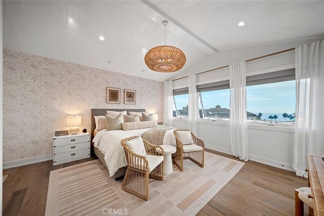 a bedroom with a bed and a lamp on dresser