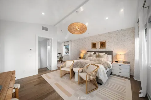 a kitchen with a table chairs refrigerator and cabinets