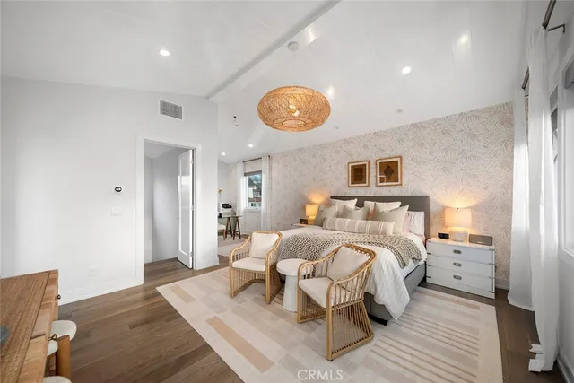 a kitchen with a table chairs refrigerator and cabinets