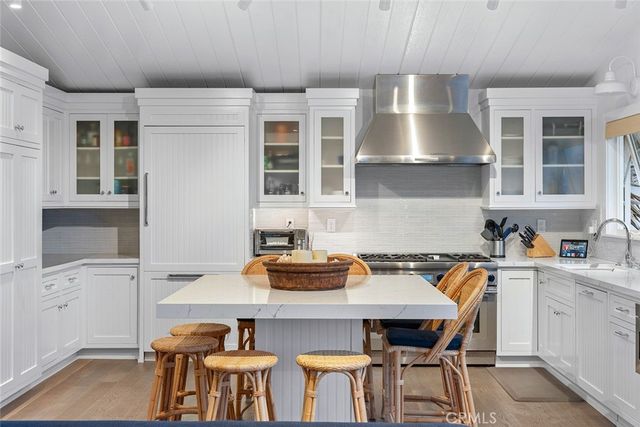 a view of a hallway with wooden floor and a potted plant