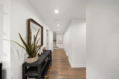 a bedroom with a bed lamp and a large window
