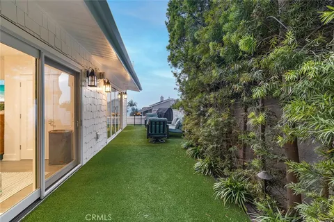 a kitchen with stainless steel appliances kitchen island granite countertop a table chairs sink and cabinets
