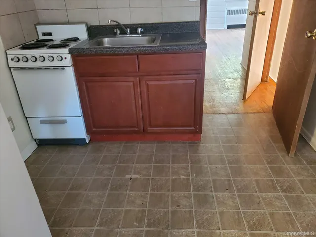 a kitchen with a stove and a refrigerator