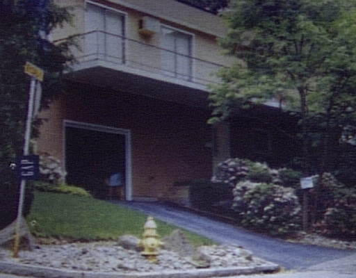 a brick building with a yard in front of it
