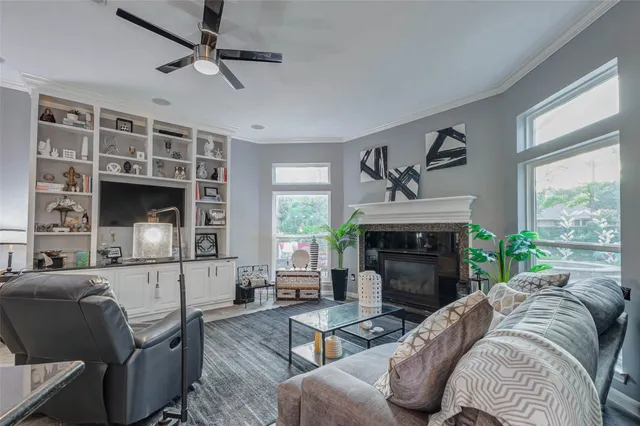 a living room with furniture a fireplace and a large window