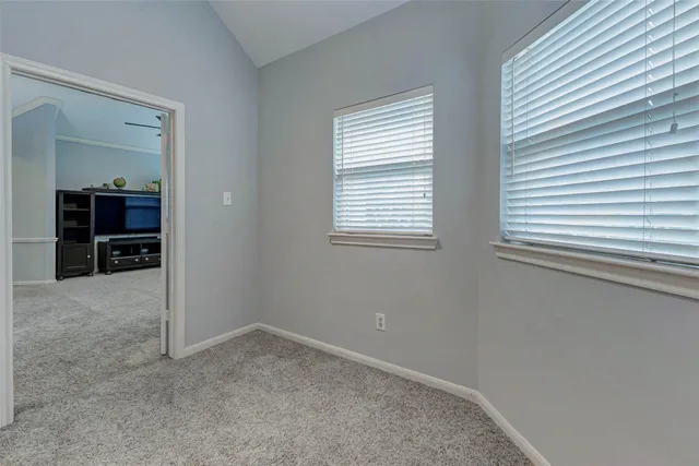 a bedroom with bed and window