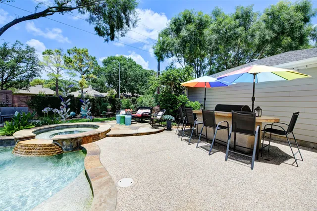 a view of a house with a patio and a yard