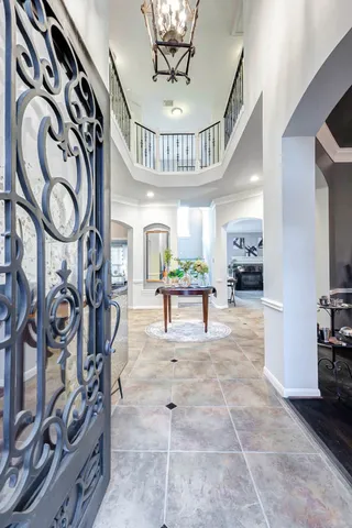 a living room with furniture and a chandelier