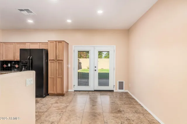 a kitchen with stainless steel appliances granite countertop a refrigerator and a stove top oven