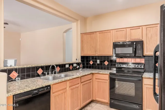 a kitchen with stainless steel appliances white cabinets and a refrigerator