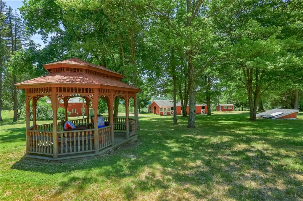 610 Dick Road Renfrew, PA 16001 - Photo 22 of 25 a view of a deck with a table and chairs under an umbrella