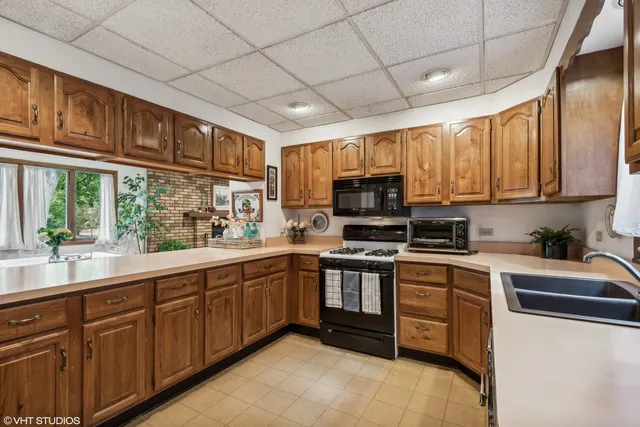 a kitchen with stainless steel appliances granite countertop a stove sink microwave and cabinets