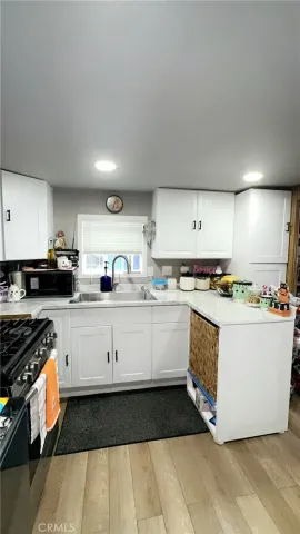 a kitchen with kitchen island granite countertop a sink and cabinets