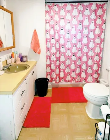 a bathroom with a sink vanity mirror and toilet