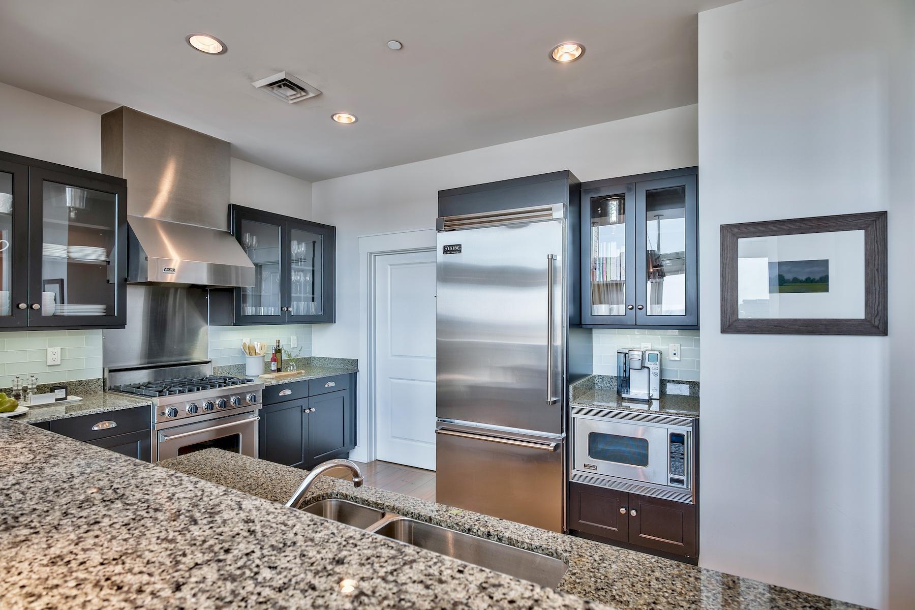 37 Compass Point Way South, Unit 420 Watersound, FL 32461 - Photo 13 of 24 a kitchen with stainless steel appliances granite countertop a refrigerator a stove and a sink