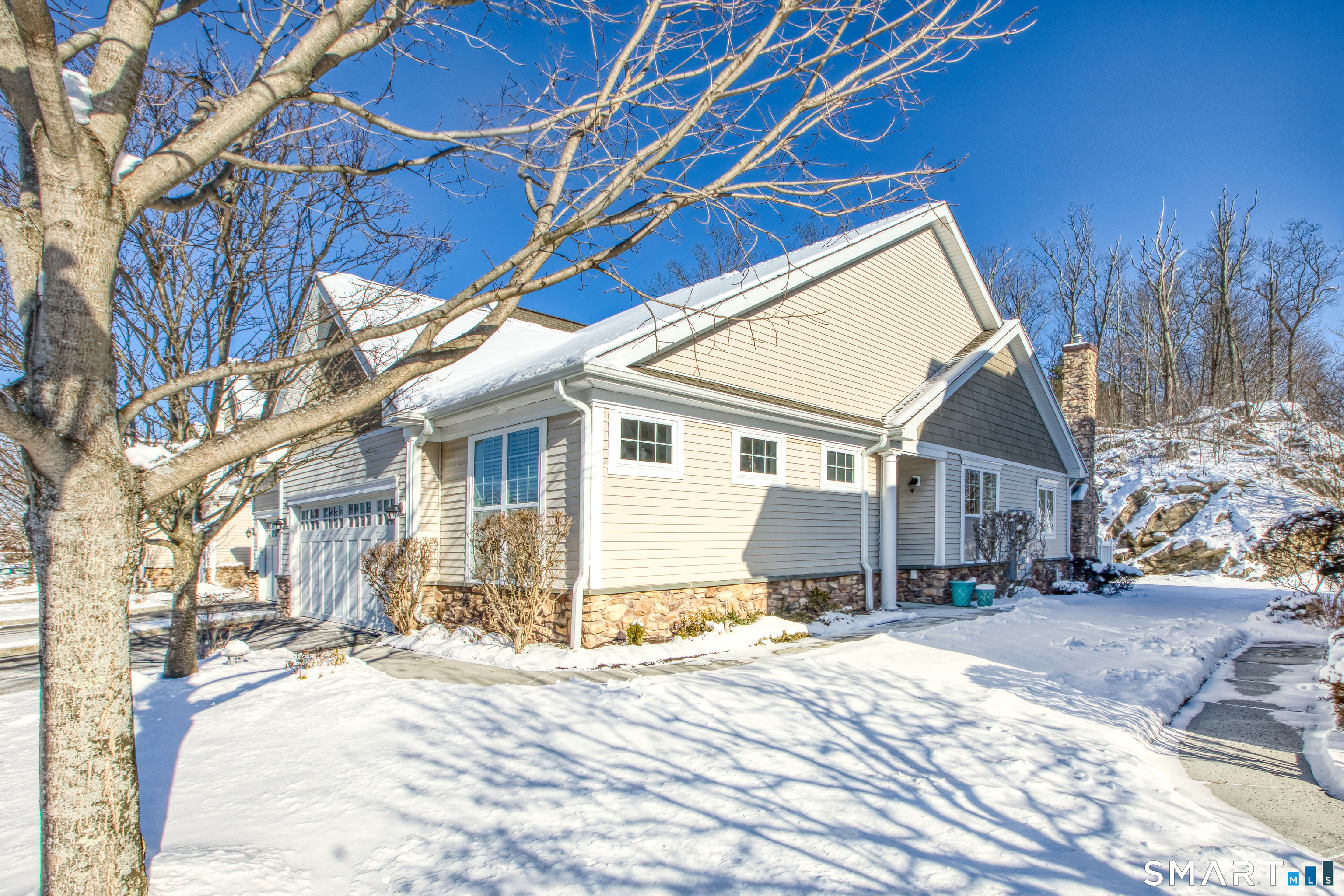 a view of a house with a snow in the yard
