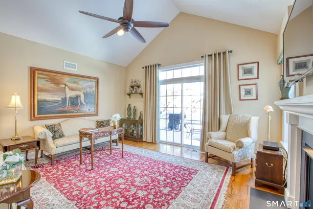 a living room with furniture a rug and a table