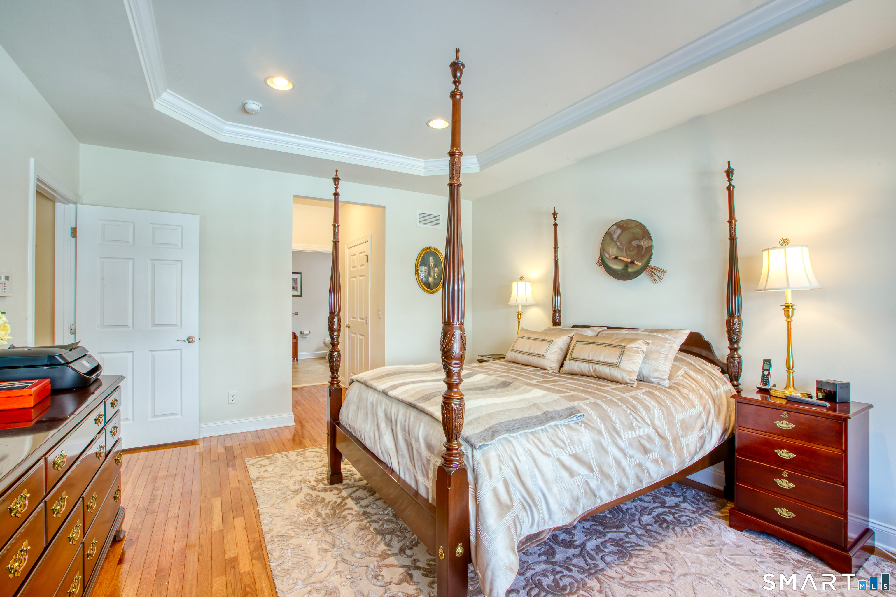 12 Briar Ridge Drive, Unit 12 Bethel, CT 06801 - Photo 17 of 34 a bedroom with a bed and a chandelier