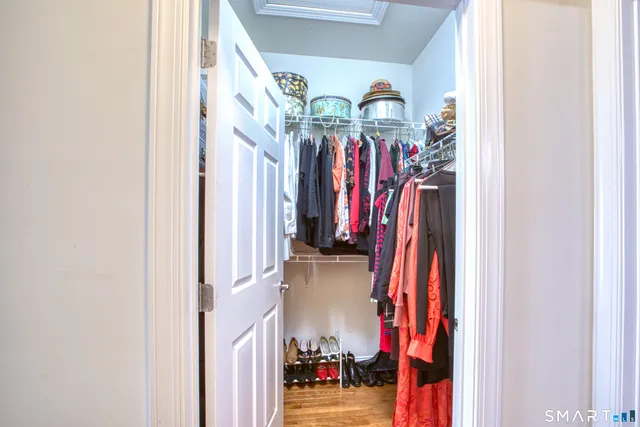 a view of walk in closet with clothes